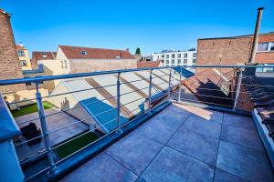 a balcony with a metal railing on a building at Automne in Brussels