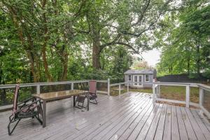 a wooden deck with a bench and a table at Pet-Friendly Mount Rainier Home with Gas Grill! in Mount Rainier