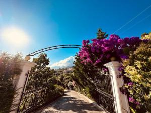 een hek met bloemen erop met een brug bij Hotel Imperial in Dhërmi