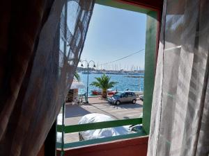 a window with a view of the water and a harbor at Apartment Surya in Rogoznica