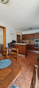 a kitchen with wooden cabinets and a table and chairs at Villa Magnetic in Baošići