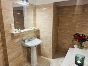 a bathroom with a sink and a mirror at Nostalgia Poganice in Potęgowo +17 photos