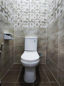La salle de bains est pourvue de toilettes blanches. dans l'établissement A One Holiday Apartment - PRO, à Tanah Rata
