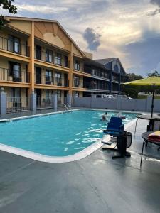 a swimming pool in front of a hotel at Days Inn & Suites Mobile in Tillmans Corner