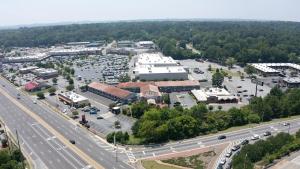 an aerial view of a parking lot next to a highway at Howard Johnson by Wyndham Columbus Fort Moore in Columbus