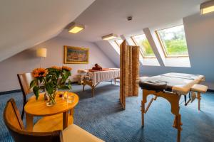 a living room with a couch and a table at Hotel Modrzewiówka in Lanckorona