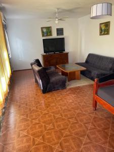a living room with a couch and a table at Apartments Sunpoint in Ulcinj