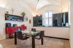 una cucina e una sala da pranzo con tavolo e sedie in vetro di Umbrian Concierge - Villa Imbriani a Perugia