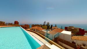 a view of a swimming pool on top of a building at 4 Bed Residential Palm Beach Fuengirola C1 in Fuengirola