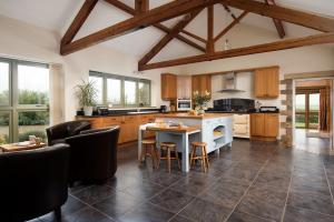 a large kitchen with a table and chairs in it at East Lodge in Bedale