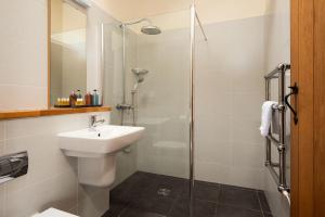 a bathroom with a toilet sink and a shower at East Lodge in Bedale