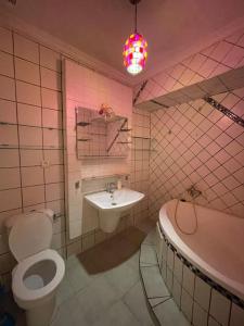 a bathroom with a toilet and a sink and a tub at Duplex a Sidi Bouzid in Sidi Bouzid