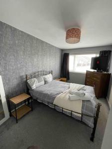 a bedroom with a bed and a television in it at Comfy Darlington Home in Darlington