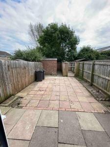 a patio with a fence and a trash can at Comfy Darlington Home in Darlington