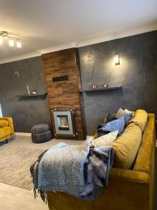 ein Wohnzimmer mit einem Sofa und einem Kamin in der Unterkunft Comfy Darlington Home in Darlington