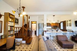 a living room and kitchen with a couch and a dining room at Μariza's escape in Afissos