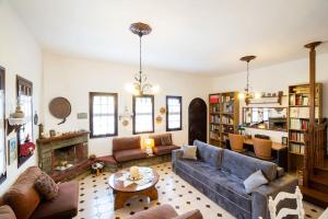 a living room with a couch and a fireplace at Μariza's escape in Afissos