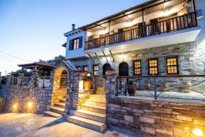 a stone house with a staircase in front of it at Μariza's escape in Afissos