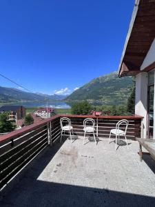 a balcony with chairs and a view of the water at Hostel Bear Hug in Plav