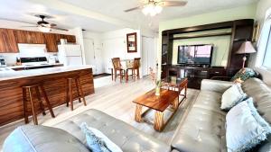 a living room with a couch and a kitchen at MAILAN HALE II in Kailua-Kona