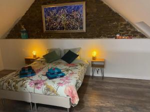 a bedroom with a bed and a painting on the wall at BnB Maison d'Art Breakfast in the Art Gallery in Ploubazlanec