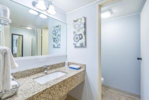 a bathroom with a sink and a mirror at Mountainside Inn 103 by Alpine Lodging Telluride in Telluride +7 photos