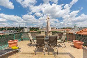 a patio with a table and chairs on a balcony at Penthouse with Free PARKING and Free BIKES, wellness 8 min walk in Budapest