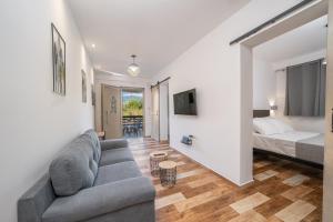 a living room with a couch and a bed at Mirabilia Apartment in Sami