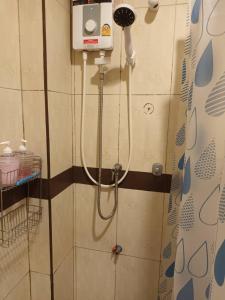 a shower in a bathroom with a shower head at Chiangmai Delight Hostel in Chiang Mai