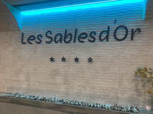 four stars on a wall with the words less collectedore at SABLE D OR in Le Grau-dʼAgde