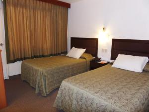 Un pat sau paturi într-o cameră la Intiotel Chiclayo
