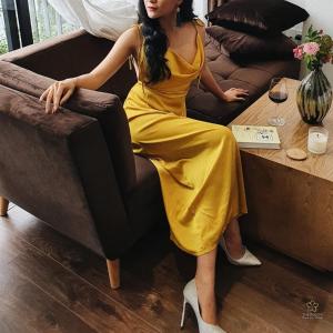 a woman in a yellow dress sitting on a couch at The Bloom Pham Viet Chanh in Ho Chi Minh City