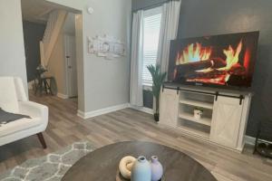 a living room with a fireplace with a tv at Cozy Portsmouth Retreat 2BR 1BA in Portsmouth