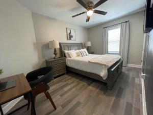 a bedroom with a bed and a ceiling fan at Cozy Portsmouth Retreat 2BR 1BA in Portsmouth