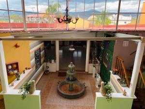 a building with a fountain in the middle of a room at Hotel Tres Flores in Huasca de Ocampo