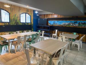 a restaurant with tables and chairs in a room at Hostel Cienfuegos in Santiago