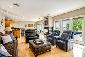 a living room with leather furniture and a fireplace at Lake View Getaway in Saugatuck