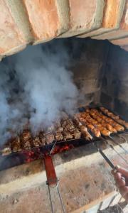 a grill with a bunch of food on it at Odo’s Guest House in Martvili