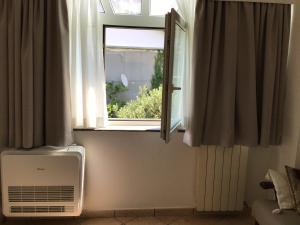 a window with a air conditioner in a room at Paravis in Piano di Sorrento