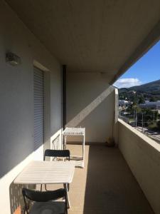 a balcony with a table and a chair on a balcony at Viale Ancona by Ospitaci in Foligno