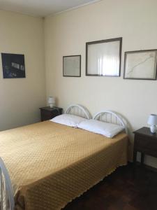 a bedroom with a bed and two pictures on the wall at Viale Ancona by Ospitaci in Foligno