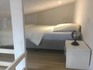 a bedroom with a bed and a table with a lamp at L’Echappée Belle in Saint-Jean-de-Fos +106 photos