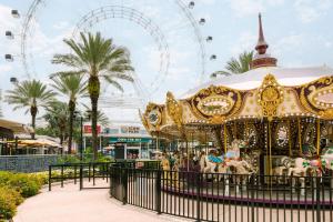 a carousel at a amusement park with a ferris wheel at Sonder Cirrus in Orlando