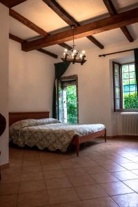 a bedroom with a bed in a room with windows at Affittacamere la Torre in Marzabotto