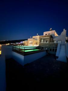 a night view of a house with a swimming pool at Sunset Villas in Mykonos by White Hills in Mikonos