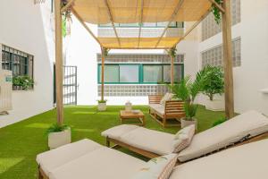 a living room with chairs and a green lawn at C30 Deluxe Studio with Terrace into Cathedral Square in Málaga