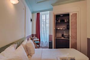 a hotel room with a bed and a table at Aparthotel AMMI Vieux Nice in Nice