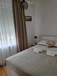 a bedroom with two beds and a window at Apartment Rose in Sesvete