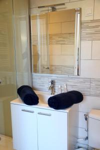 a bathroom with a sink with two pillows on it at PLUTON in Saint-Quentin
