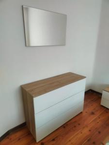 a white dresser in a room with a mirror at Lavanda House in Vicenza